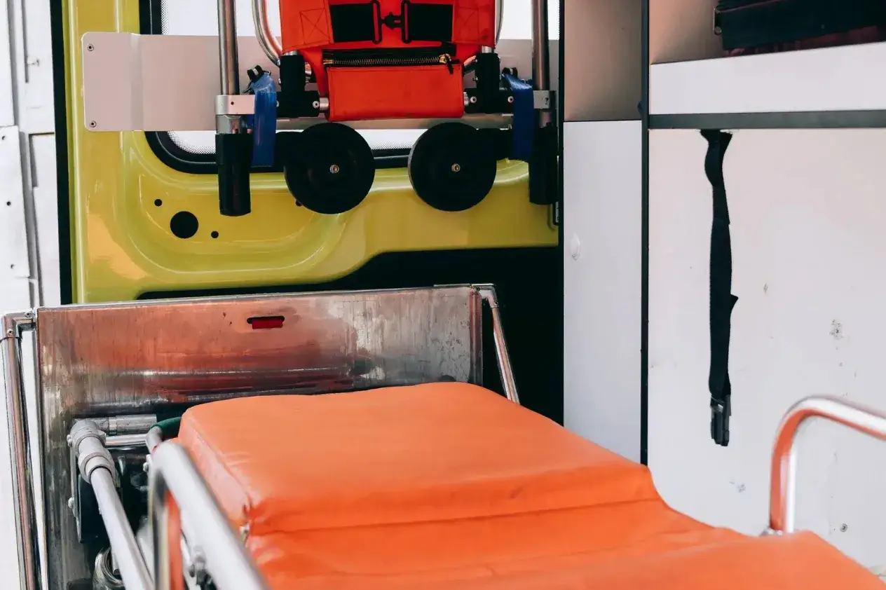 Orange stretcher and folded equipment inside an emergency vehicle
