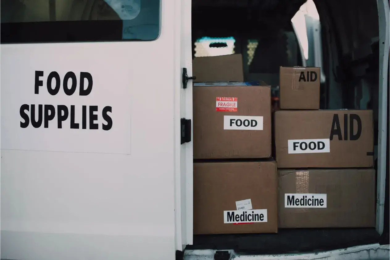 Boxes labelled Food, Aid and Medicine loaded inside a vehicle